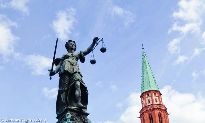 Jusitiza vor Kirchturm