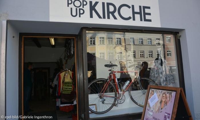 Ein Fahrrad von Ferrari im Schaufenster der PopUp Kirche in Landshut.