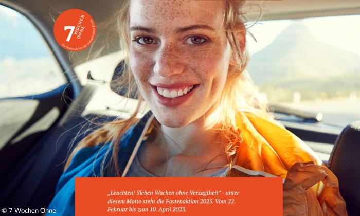 Eine Frau lacht, Sonne scheint ihr in den Nacken