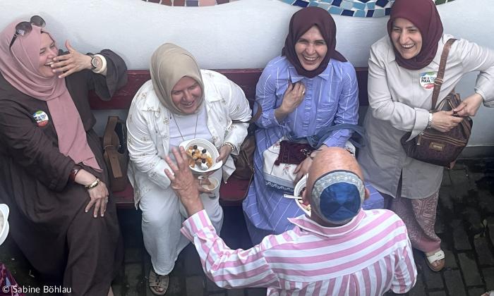 Fünf Menschen stehen zusammen und lachen