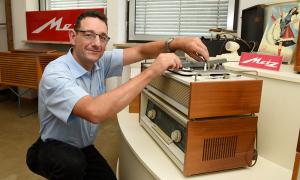 Martin Schramm, Amtsleiter für Stadtarchiv und Museen der Stadt Fürth, demonstriert im Rundfunkmuseum Fürth einen alten, analogen Plattenspieler.
