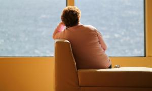 Eine Frau schaut alleine aufs Meer