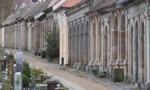 Viele steinerne Grüfte an einem kleinen Weg am Ansbacher Stadtfriedhof.