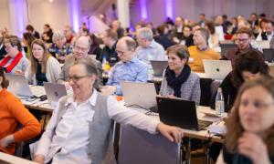 Menschen sitzen in einem Saal